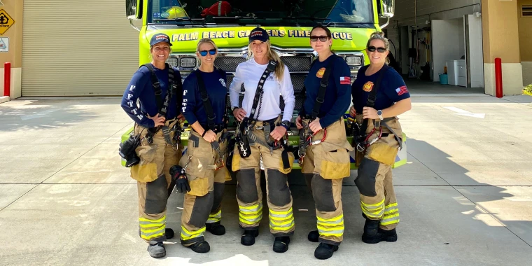 West Palm Beach firefighters pose in front of a rescue vehicle