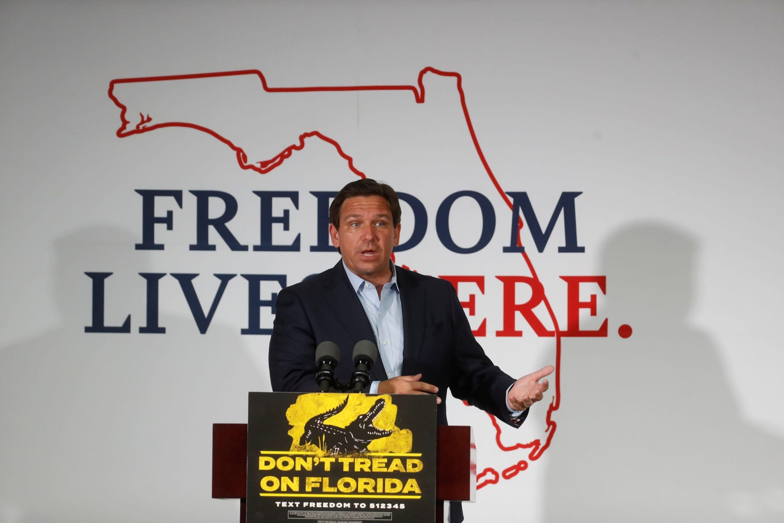 DeSantis speaking in front of a "Free State of Florida" banner